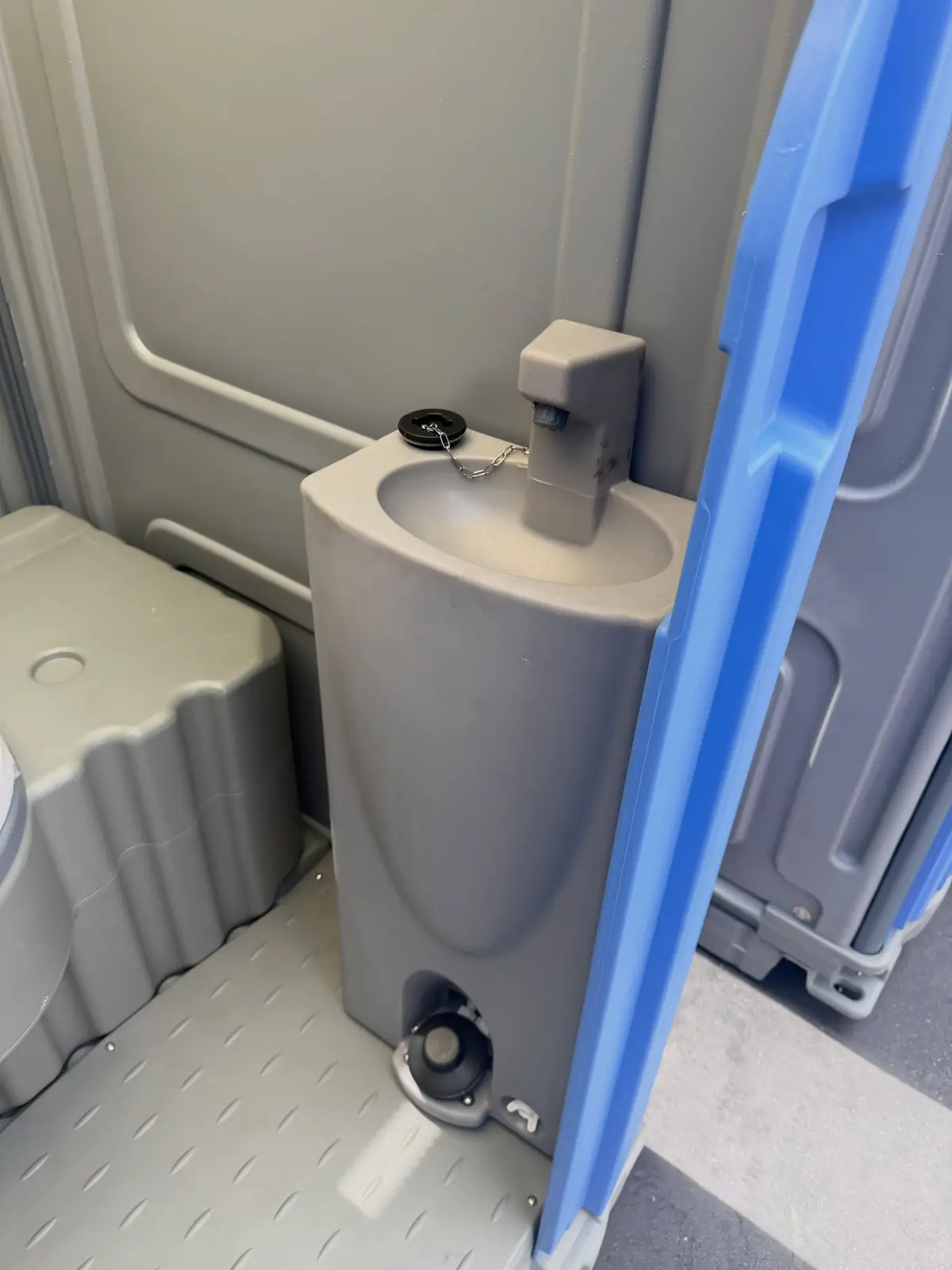 Foot-pump sink inside a deluxe porta potty