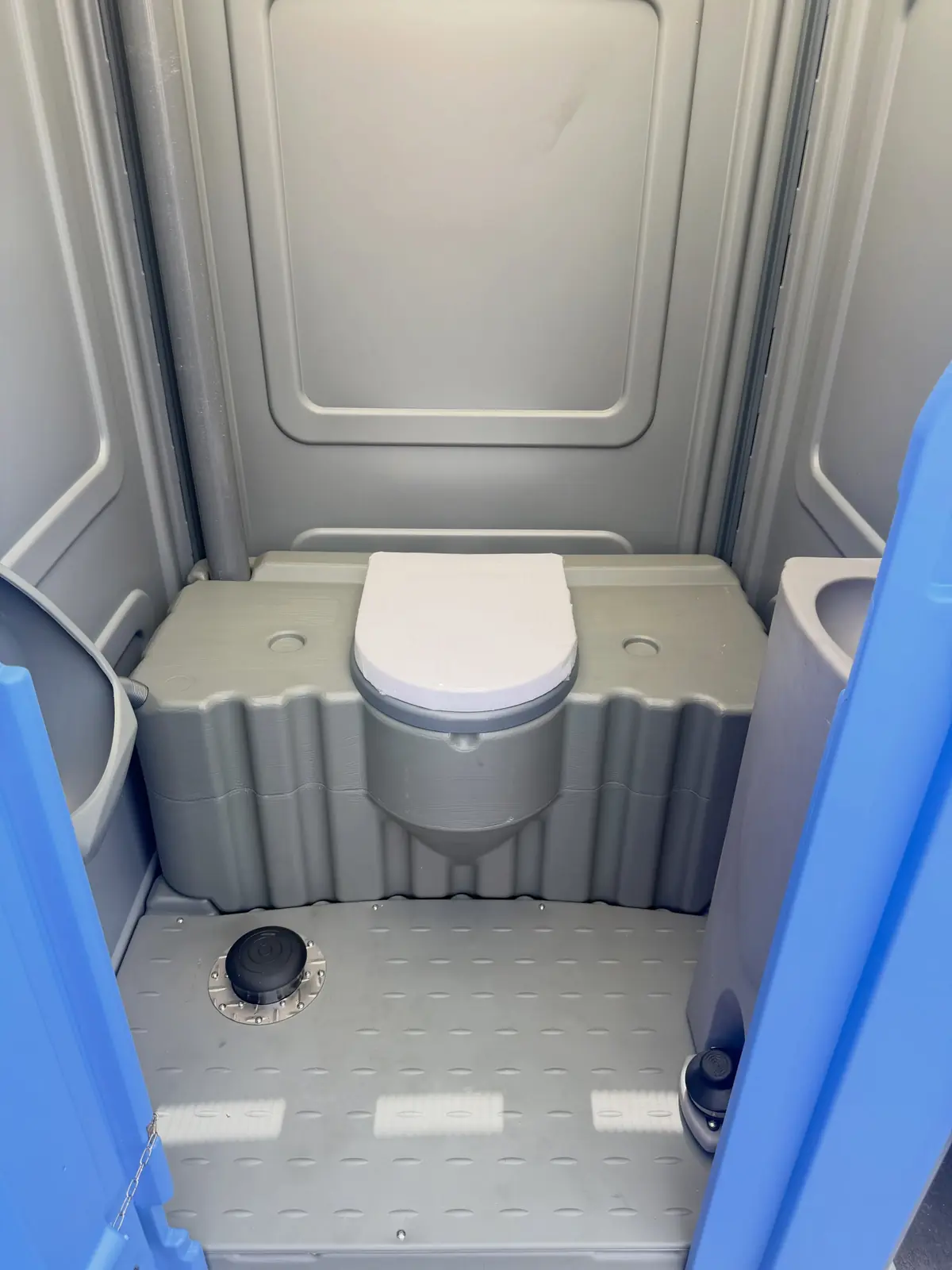 Lowered toilet seat inside a portable restroom