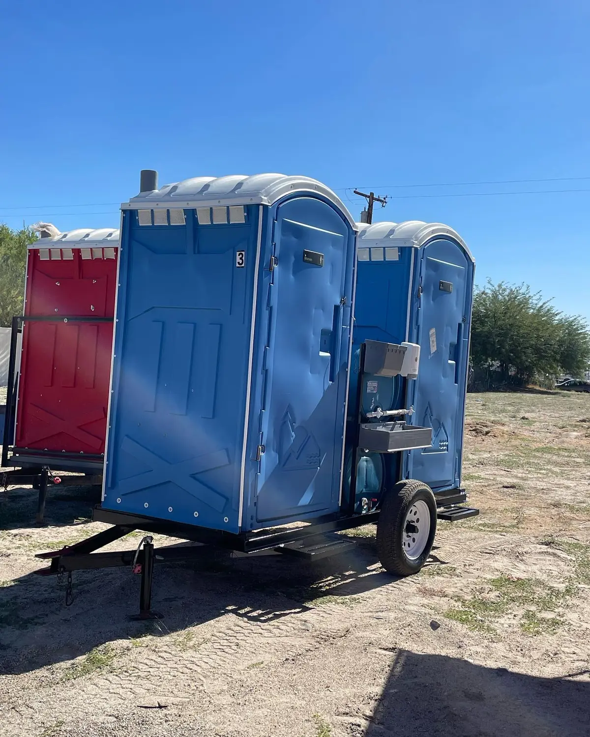 Portable toilets set for a rental like those we deliver in Stow