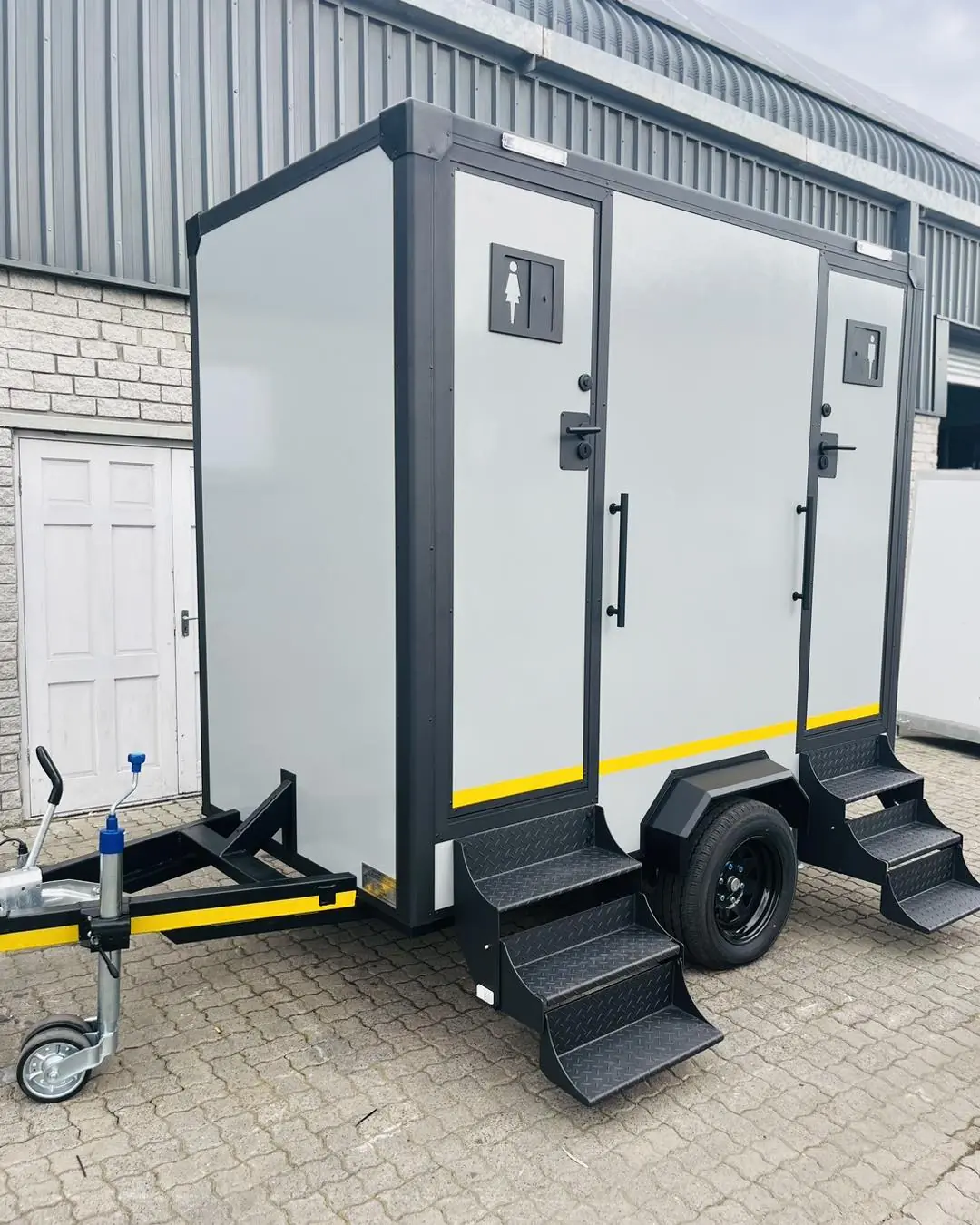 Two-stall restroom trailer exterior with steps and two doors